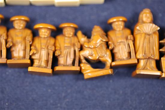 An unusual late 19th century Japanese brown stained and natural ivory figural chess set, kings 1.75in.